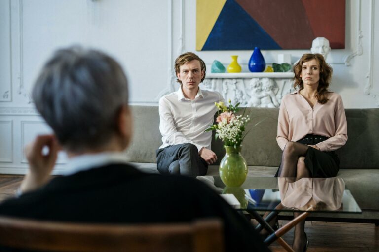 A couple consulting with a therapist in a modern studio setting.